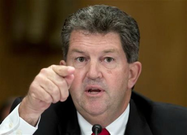 Postmaster General Patrick Donahoe gestures as he speaks during the Senate Homeland Security and Governmental Affairs - postmaster